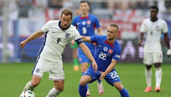 Englands forward #09 Harry Kane and Slovakias midfielder #22 Stanislav Lobotka fight for the ball during the UEFA Euro 2024 round of 16 football match between England and Slovakia at the Arena AufSchalke in Gelsenkirchen on June 30, 2024. — AFP