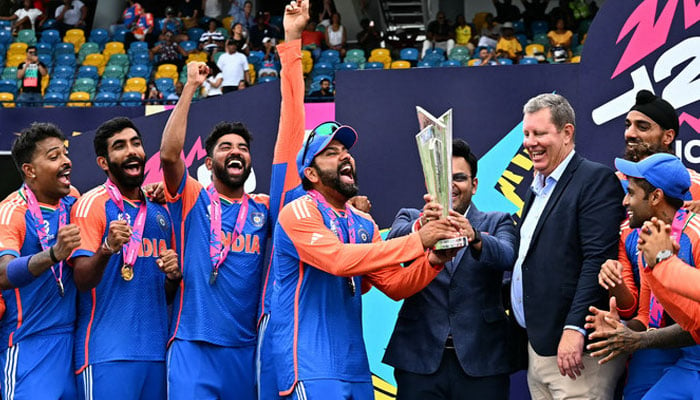 Indias captain Rohit Sharma (4th L) and Jay Shah (4th R), Secretary of the Board of Control for Cricket in India (BCCI), accept the trophy from Greg Barclay (3rd R), chairman of the International Cricket Council (ICC), as Team India celebrates after winning the ICC mens Twenty20 World Cup 2024 final cricket match against South Africa in Bridgetown, Barbados, on June 29, 2024. — AFP