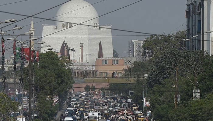 This undated photograph shows commuters driving on a busy MA Jinnah Road in Karachi as the mausoleum of Quaid-e-Azam Muhammed Ali Jinnah is visible in the backdrop. — AFP/File