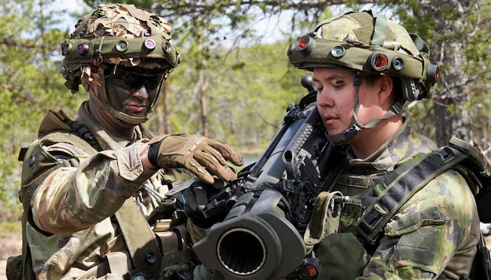 A U.S. soldier instructs a Finnish soldier on the Carl Gustaf recoilless rifle during the Northern Forest land force exercise in Rovajarvi, Finland May 30, 2023. — Reuters