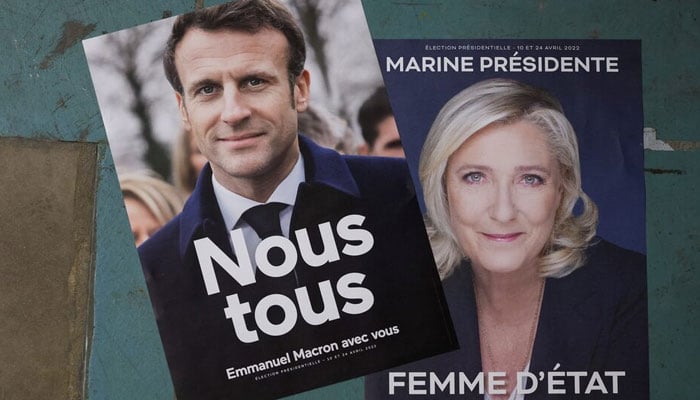Official campaign posters of French President  Emmanuel Macron, and Marine Le Pen, leader of French far-right National Rally (Rassemblement National) party, at the are displayed at France Affichage Plus dispatch hub in Mitry-Mory, outside Paris, France, March 22, 2022. — Reuters