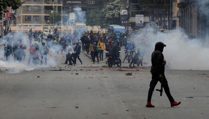 A police officer walks after using tear gas to disperse protesters during a demonstration over police killings of people protesting against Kenyas proposed finance bill 2024/2025, in Nairobi, Kenya, on June 27, 2024. — Reuters