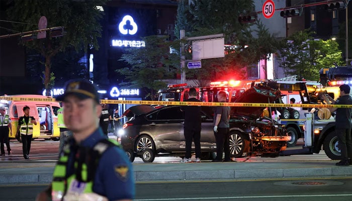 Police and rescuers stand next to a car involved in accident that resulted in several people killed and injured in central Seoul, South Korea July 1, 2024. — Reuters
