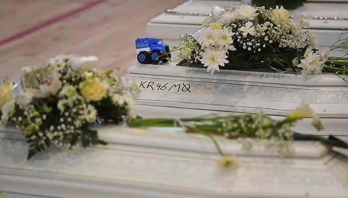 A representational image showing flowers placed on coffins at a funeral. — AFP/File
