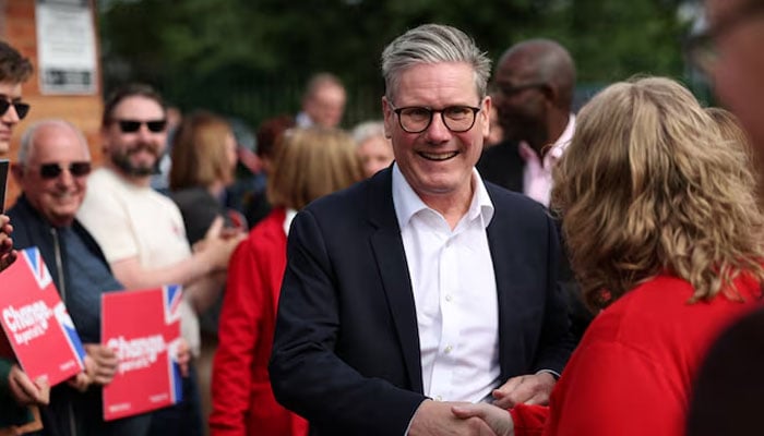 British opposition Labour Party leader Keir Starmer greets a person as he attends a Labour general election campaign event, in Norton Canes, Britain on July 2, 2024. — Reuters