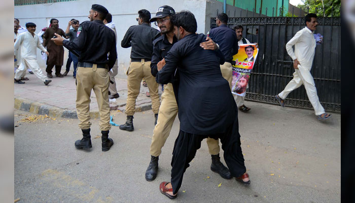 Police officials barricade protesters when they tried to move towards the red zone area during the protest demonstration of Basic NCHD Teachers Committee Sindh for acceptance of their demands, near Karachi Press Club on July 3, 2024. — PPI