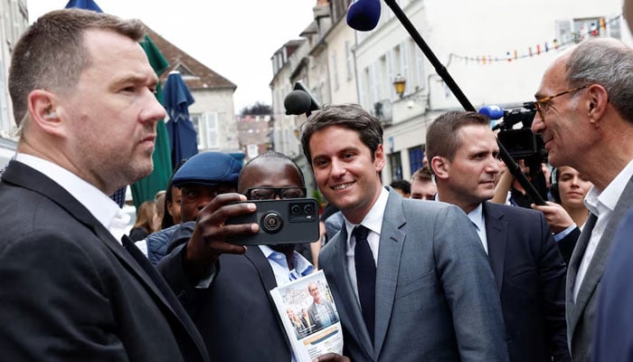 French Prime Minister Gabriel Attal and Eric Woerth, Renaissance candidate for the fourth constituency of Oise, campaign before the second round of the early French parliamentary elections, in Senlis, north of Paris, France, on July 3, 2024. — Reuters