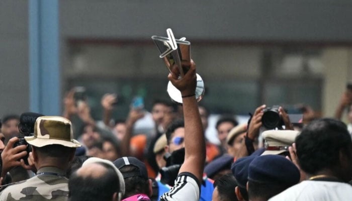 India captain Rohit Sharma lifts the T20 World Cup among crowds of fans as the team arrive back in New Delhi. — AFP/file