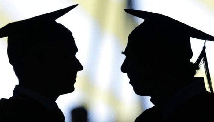 A representational image of the silhouette of two students wearing graduating caps. — AFP/File