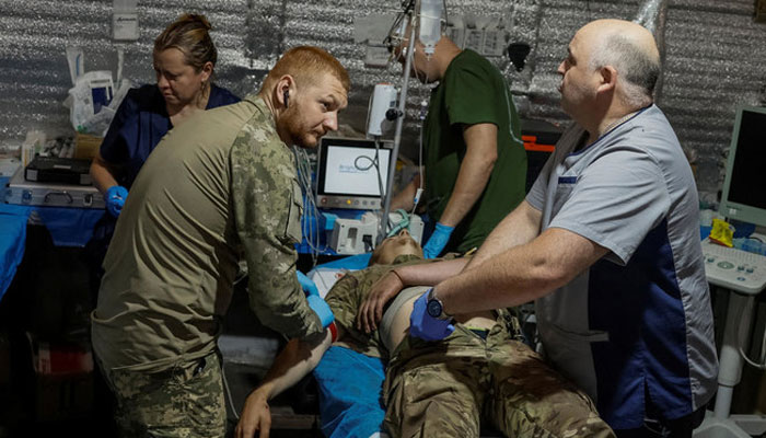 Medics help a wounded Ukrainian serviceman inside a medical stabilization point of the 5th Separate Assault Kyiv Brigade near the town of Chasiv Yar, in Donetsk region, on Jul. 1, 2024. — Reuters