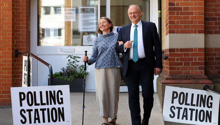 British leader of the Liberal Democrats party Ed Davey and his wife Emily Gasson leave a polling station after voting during the general election in London, Britain, July 4, 2024. — Reuters