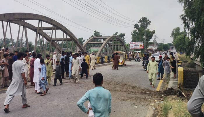 People gathering at the site of the blast near Jalala bridge in the Takhtbhai area of Mardan, Khyber Pakhtunkhwa, on July 5, 2024. — reporters