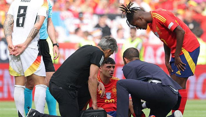 Spains midfielder #20 Pedri speaks with medics during the UEFA Euro 2024 quarter-final football match between Spain and Germany at the Stuttgart Arena in Stuttgart on July 5, 2024. — AFP