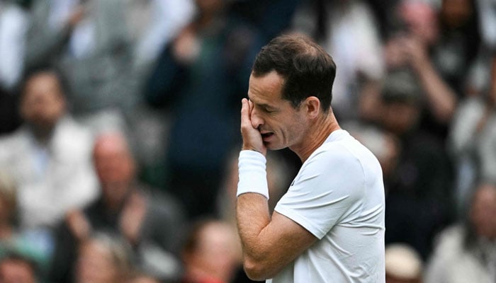 Britains Andy Murray cries as he delivers a speech at the end of his mens doubles tennis match with his brother Britains Jamie Murray, during a farewell ceremony to celebrate his last Wimbledon, on the fourth day of the 2024 Wimbledon Championships at The All England Lawn Tennis and Croquet Club in Wimbledon, southwest London, on July 4, 2024. —AFP