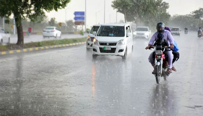 Motorists at Murree Road during heavy rainfall of the pre-monsoon spell in Islamabad on July 3, 2023. — Online