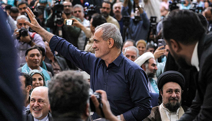 Irans newly-elected President Masoud Pezeshkian (C) waves to supporters as he visits the shrine of countrys former supreme leader Ayatollah Ruhollah Khomeini in Tehran on July 6, 2024. — AFP