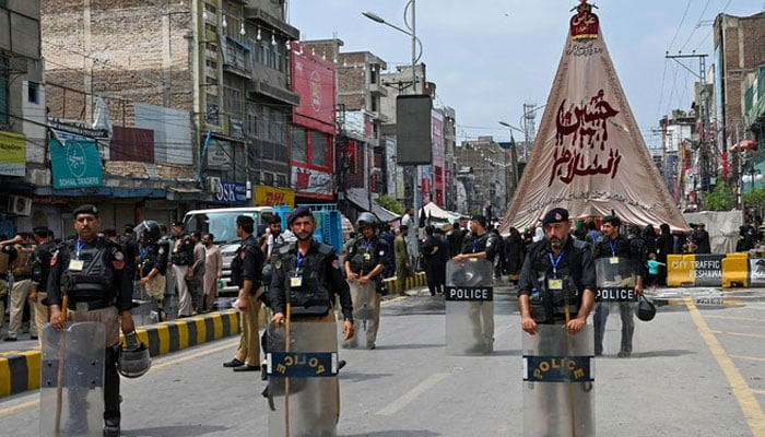 Security personnel patrol a street during a procession on the ninth day of Ashura in the Islamic month of Muharram in Peshawar on July 28, 2023, — AFP/file