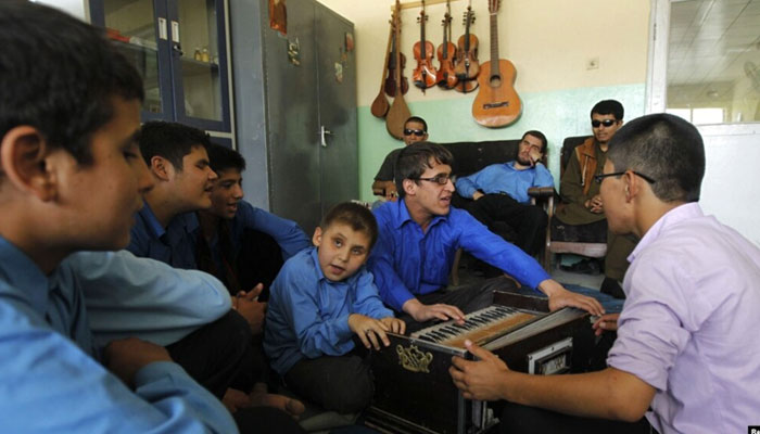 Visually impaired students play musical instruments during a music lesson at the Blind School. — Reuters/file