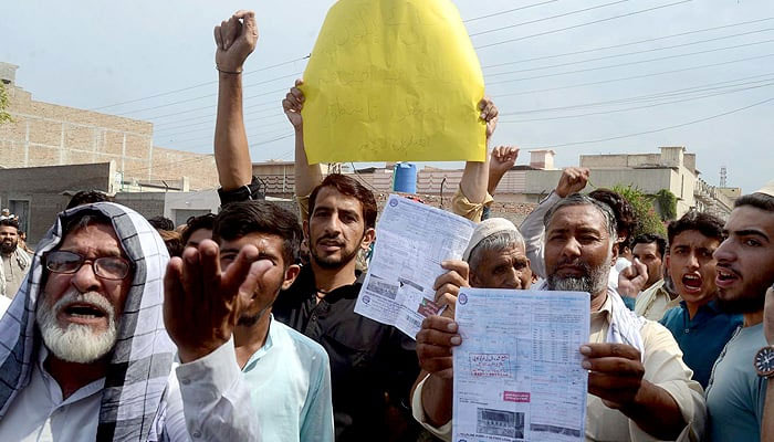 Citizens are holding protest demonstration against overbilling by electricity company, at Gulbahar area in Peshawar on Friday, August 25, 2023. — PPI