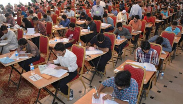 Students give entry test in Examination hall for admission in University Education. — APP/File