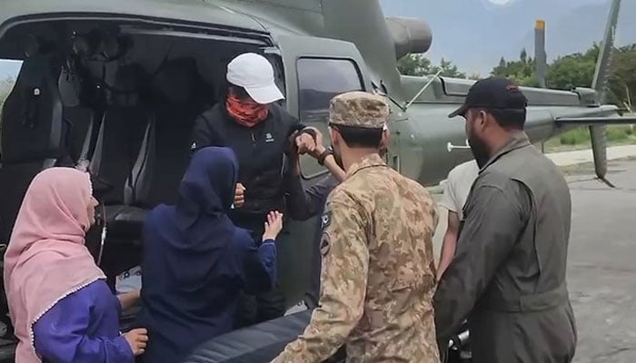 In this screengrab, taken from a handout video released by Pakistan’s Inter-Service Public Relations (ISPR) on July 7, 2024, military officials rescue Pakistani mountaineer Samina Baig from K2 base camp. — ISPR