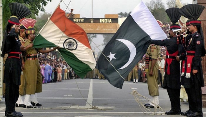 Representational image shows Pakistani (R) and Indian border security personnel holding flags of their country at the border. — AFP/File