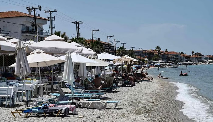 People seen on multiple sunbeds at a beach in this undated image. — AFP/file