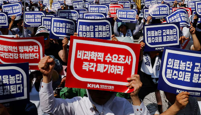 Doctors strike and shout slogans during a rally to protest against government plans to increase medical school admissions and healthcare reform in Seoul, South Korea, June 18, 2024. — Rreters