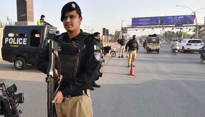 Police personnel stand alert in Karachi on February 2, 2024. — INP