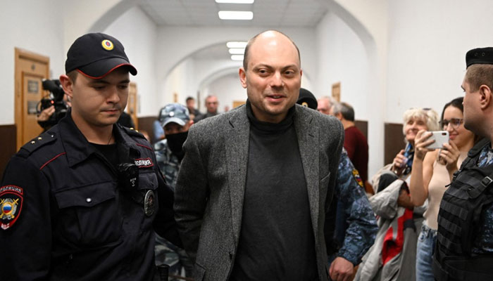 Russian opposition activist Vladimir Kara-Murza is escorted for a hearing at the Basmanny court in Moscow on Oct. 10, 2022, — AFP