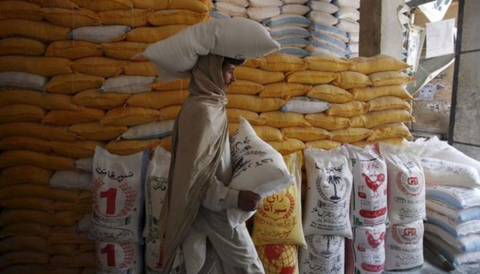 A representational image of a man carrying bags of flour. — Reuters/File