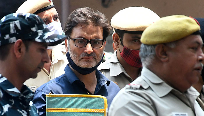 Yasin Malik, chairman of Jammu Kashmir Liberation Front (JKLF) is escorted by Indian police officers at a court premises in New Delhi, India, May 25, 2022. — Reuters