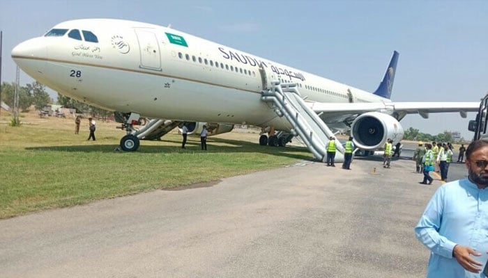 Saudi Airlines flight 792 stands stationary at Peshawar Airport after its landing gear caught fire on July 11, 2024. — Civil Aviation Authority