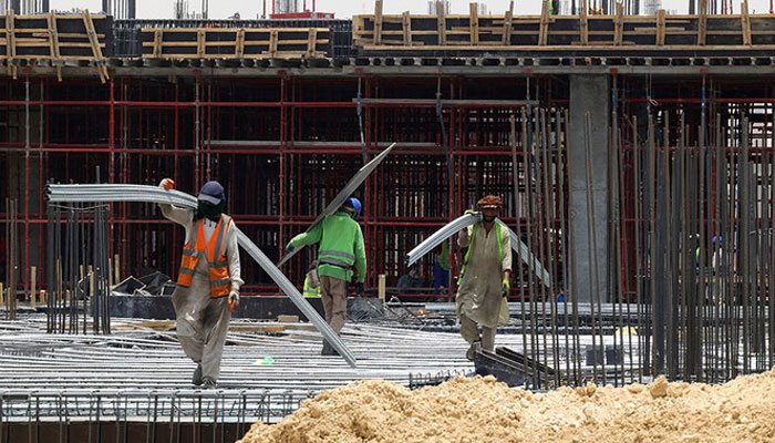 A representational image showing labourers working on a building construction site. — AFP/File