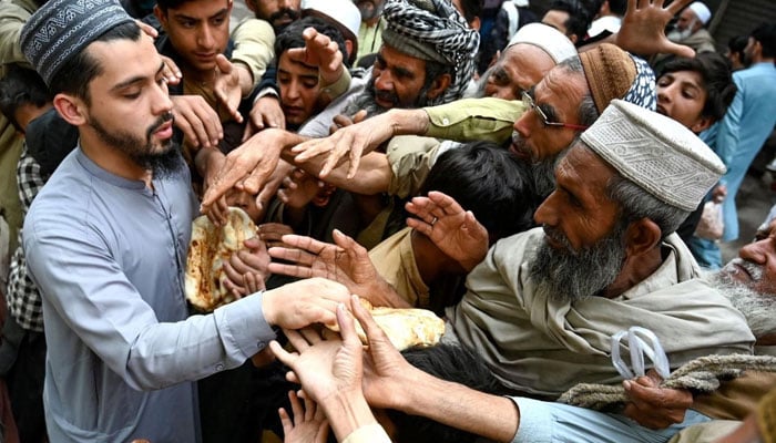 A representational image distributing free flat bread (roti) in Peshawar, Khyber Pakhtunkhwa on April 3, 2023. — AFP