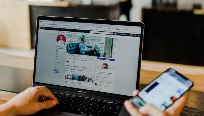 Facebook page of an entrepreneurs social media on desktop and mobile.— Unsplash