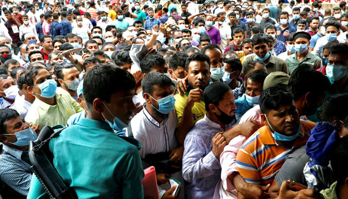 Police try to control the crowd as stranded Bangladeshi workers gatheroutside of the Biman Bangladesh Airlines office, demanding flight tickets to go back to Saudi Arabia, in Dhaka, Bangladesh, September 24, 2020. — Reuters