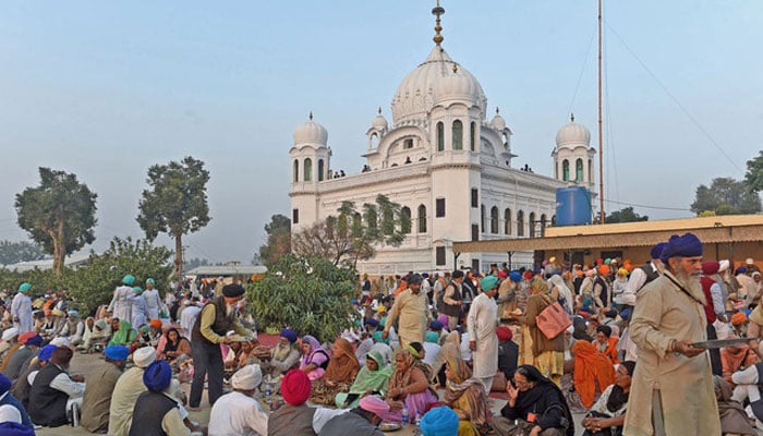 In this file photo, Sikh Pilgrims eat food in front of Kartarpur Gurdwara Sahib after a groundbreaking ceremony for the Kartarpur Corridor in Kartarpur on Nov. 28, 2018. — AFP