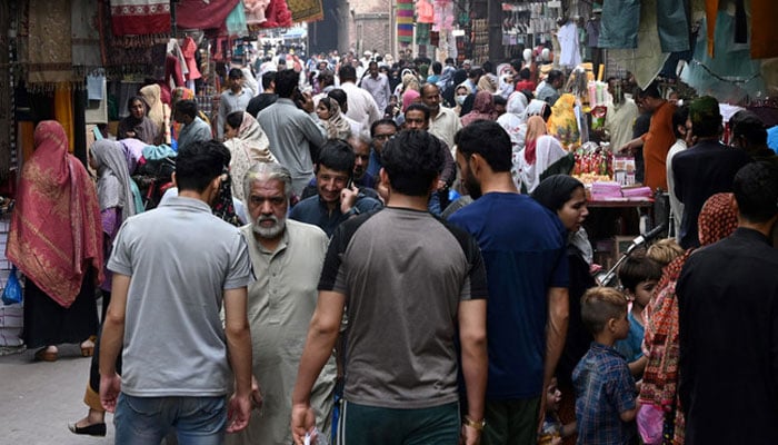 People throng a market area in Lahore. — AFP/File