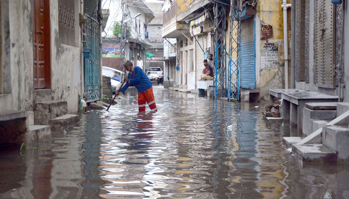 A resident throwing rain water accumulated in his house at Dhok Illahi Baksh after the heavy rain in morning hours in Rawalpindi on July 12, 2024. — Online