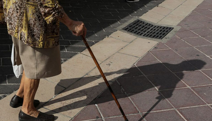 An elderly woman walks in a street on September 4, 2019. — Reuters