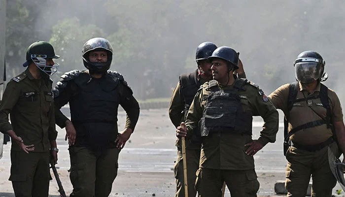 Policemen stand guard after a protest in Lahore. — AFP/File