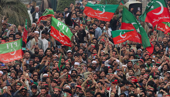 Supporters of former Prime Minister Imran Khans party, the Pakistan Tehreek-e-Insaf (PTI), wave flags as they protest demanding free and fair results of the elections, in Peshawar on February 17, 2024. Reuters