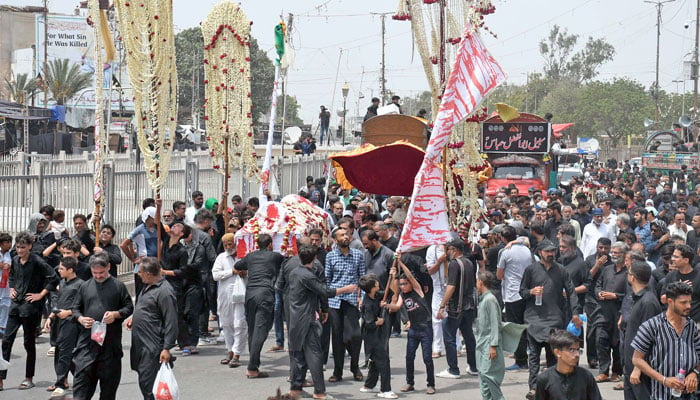 Devotees of Imam Hussain (R.A) are holding a religious mourning procession in memory of the martyrdom of Hazrat Imam Hussain (R.A), grandson of Prophet Mohammad (PBUH), in connection of 8th Muharram-ul-Haram, in Karachi on July 15, 2024. — Online