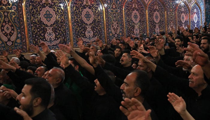 Muslims mourners take part in a mourning ritual in Iraqs central city of Karbala on July 12, 2024, during the month of Muharram, ahead of Ashura, to remember the martyrdom of  Prophet Mohammed´s  (PBUH) grandson Imam Hussein (RA). — AFP