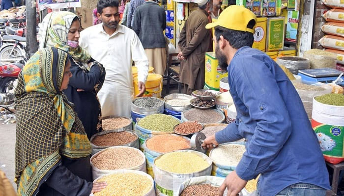 Women buy groceries at a wholesale market in Lahores Akbari Market. — Online/File