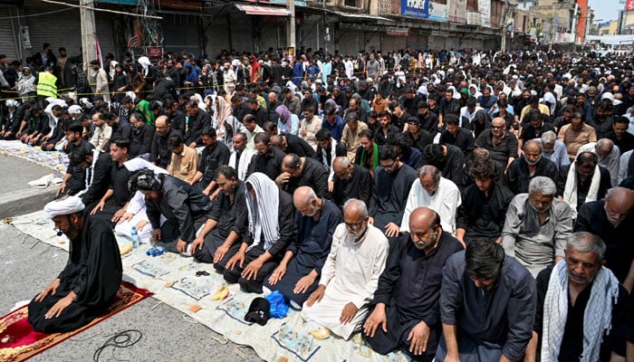 Muslim mourners offer prayers during a religious procession to mark Ashura on the tenth day of the Islamic month of Muharram in Rawalpindi on July 17, 2024. — AFP