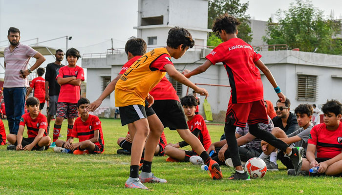 Boys playing with a football in this undated image.— Karachiunited.com/file