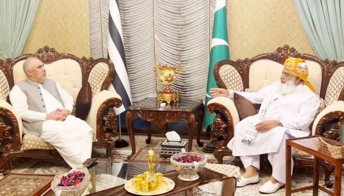 PTIs senior leader Asad Qaiser (left) during the meeting with JUI-F chief Maulana Fazlur Rehman (right). — X/@juipakofficial/file