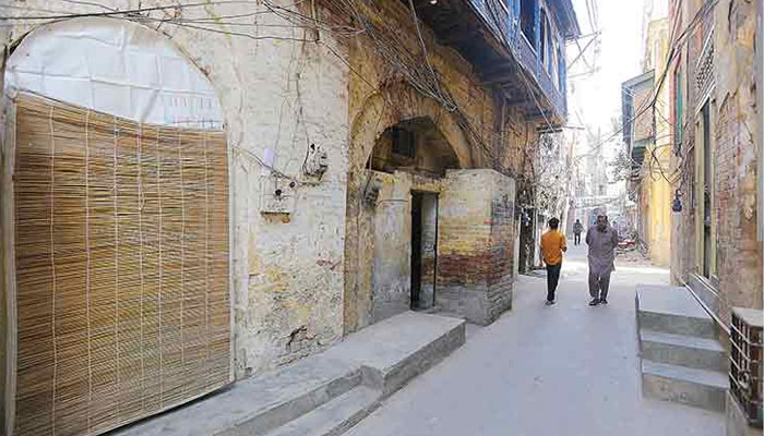 People are walking through a street of a Lahore’s pre-partition era building. — The News/File